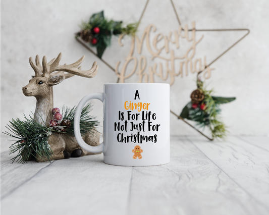 An 11oz white mug with a design to the front saying 'A Ginger Is For Life Not Just For Christmas' with a picture of a Gingerbread person